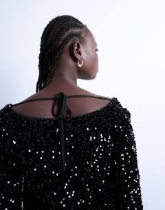 Model wearing Longsleeve cowl back mini sequin velvet dress in black