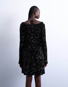 Model wearing Longsleeve cowl back mini sequin velvet dress in black