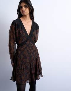 Model wearing Longsleeve lace trim mini tea dress in dark based floral