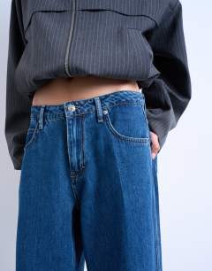 Model wearing Lounge low rise jean in vintage blue