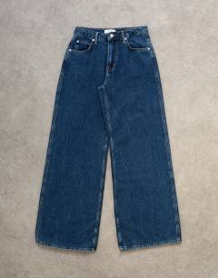 Model wearing Lounge low rise jean in vintage blue