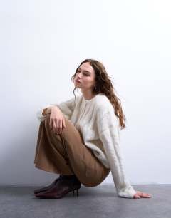 Model wearing Low rise flared trouser in brown