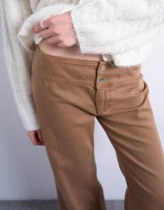 Model wearing Low rise flared trouser in brown