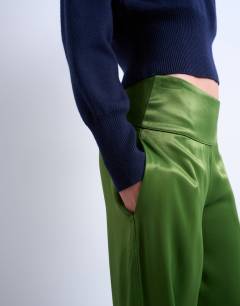 Model wearing Low rise satin trouser in green