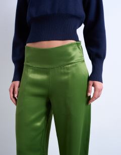 Model wearing Low rise satin trouser in green