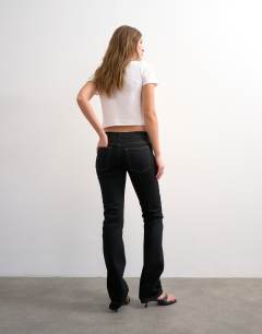 Model wearing Low rise slim leg jean in black
