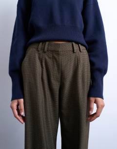 Model wearing Low slung tailored trouser in green heritage check