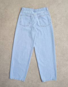Model wearing Lowrie low rise baggy jeans in bleach