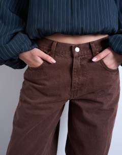 Model wearing Lowrie low rise baggy jeans in chocolate