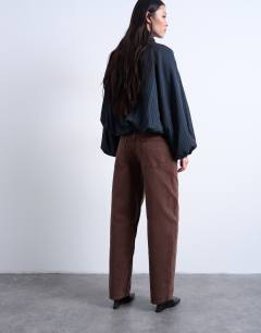 Model wearing Lowrie low rise baggy jeans in chocolate