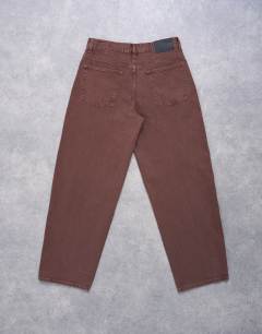 Model wearing Lowrie low rise baggy jeans in chocolate