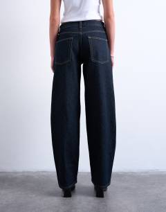 Model wearing Lowrie low rise baggy jeans in indigo rinse