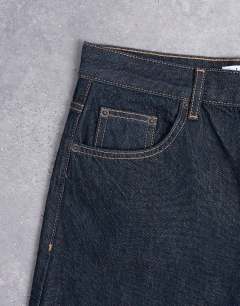 Model wearing Lowrie low rise baggy jeans in indigo rinse