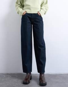 Model wearing Lowrie low rise baggy jeans in indigo rinse