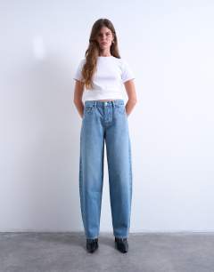 Model wearing Lowrie low rise baggy jeans in mid blue
