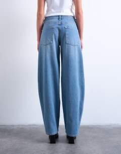 Model wearing Lowrie low rise baggy jeans in mid blue