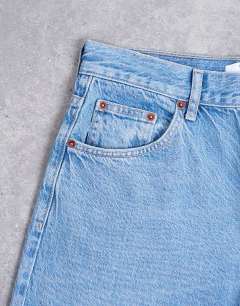 Model wearing Lowrie low rise baggy jeans in mid blue
