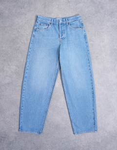 Model wearing Lowrie low rise baggy jeans in mid blue