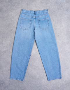 Model wearing Lowrie low rise baggy jeans in mid blue