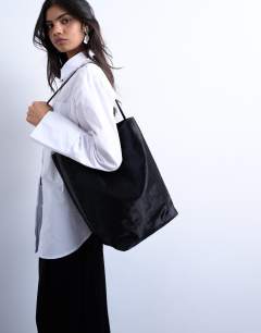 Model wearing Luna real leather tote bag in black pony