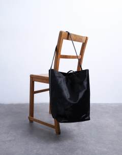 Model wearing Luna real leather tote bag in black pony