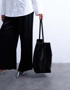 Model wearing Luna real leather tote bag in black pony