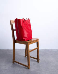 Model wearing Luna real leather tote bag in red pony