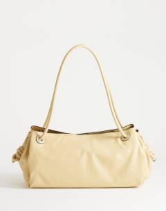 Model wearing Maddie large shoulder bag in buttermilk