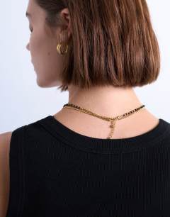 Model wearing Maddox stainless steel multi chain necklace with black beads in gold
