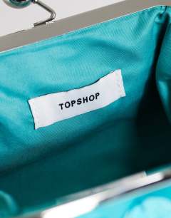 Model wearing Maeve small embellished grab bag in turquoise