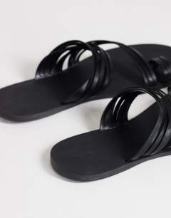 Model wearing Maeve strappy toe loop sandal in black