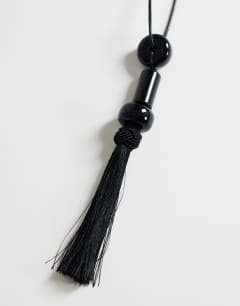 Model wearing Magnus cord necklace with beads and tassel in black