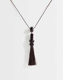 Model wearing Magnus cord necklace with beads and tassel in chocolate