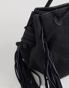 Model wearing Maisie large shoulder bag with real leather tassels in black