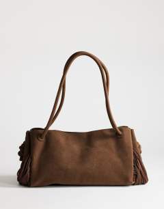 Model wearing Maisie large shoulder bag with real leather tassels in choc