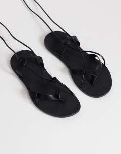 Model wearing Maisie strappy flat sandal in black