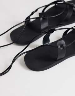 Model wearing Maisie strappy flat sandal in black
