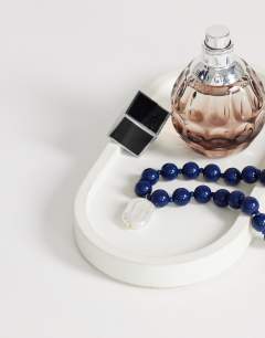 Model wearing Marais beaded necklace with pearl charm in blue and white faux marble