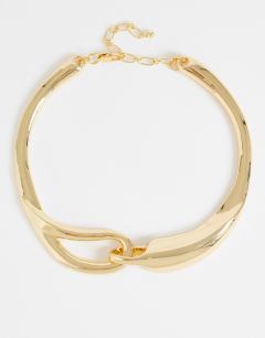 Model wearing Mario statement necklace in gold
