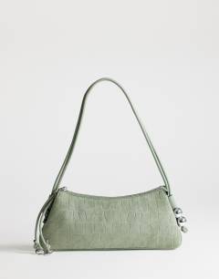 Model wearing Marley small croc suede shoulder bag in green