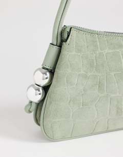 Model wearing Marley small croc suede shoulder bag in green