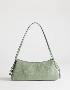 Model wearing Marley small croc suede shoulder bag in green