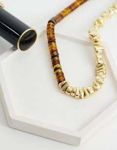 Model wearing Mateo beaded necklace in gold and orange