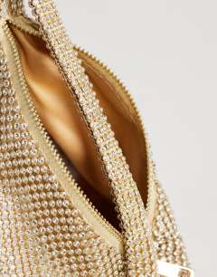 Model wearing Matty small diamante triangle grab bag with tassels in gold
