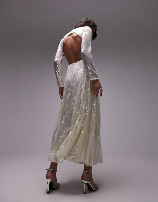 Topshop sequin embellished maxi dress with long sleeves and open back. This floor-sweeping maxi has a high Round neck, Long sleeves, an Open back and figure skimming fit with slightly swooshy skirt. 