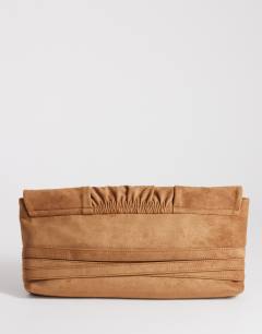 Model wearing Meadow oversized strap clutch in tan