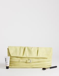 Model wearing Meadow strap clutch in chartreuse