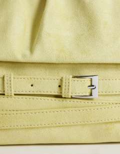 Model wearing Meadow strap clutch in chartreuse