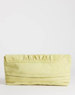 Model wearing Meadow strap clutch in chartreuse