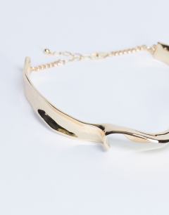 Model wearing Megan statement necklace in gold